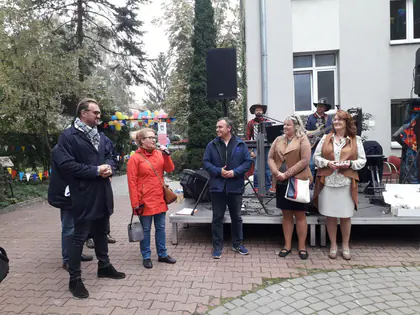 Goście i organizatorzy pikniku przed sceną na podwórku